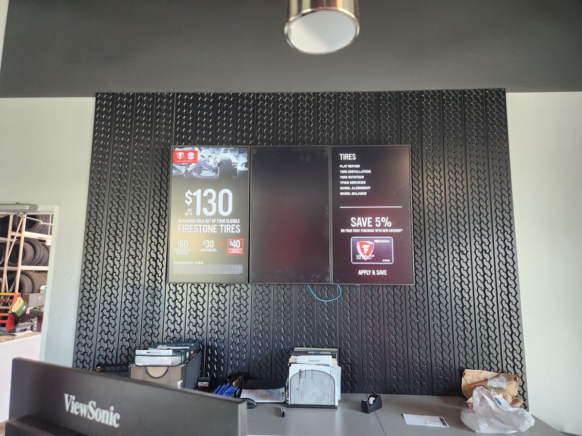 Dual screen digital menu board at Firestone auto service center