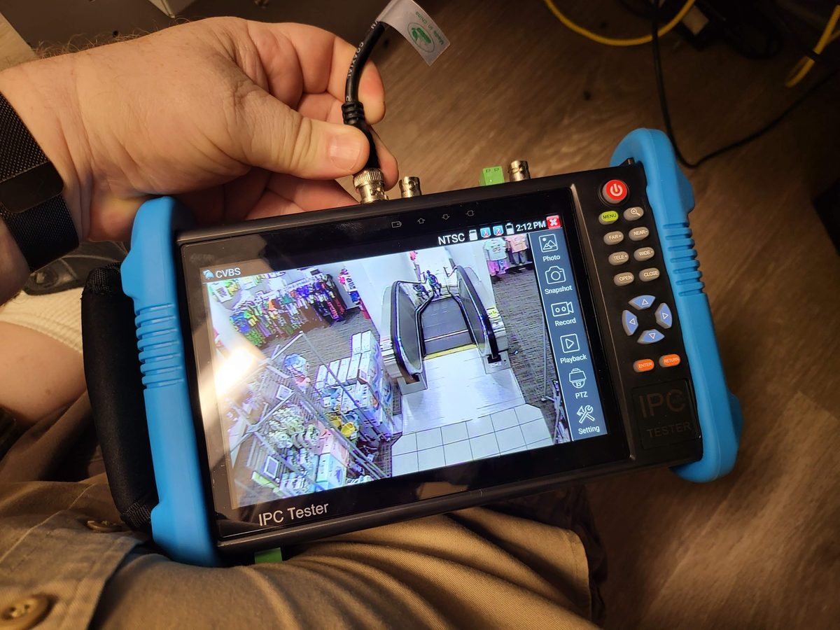 DR TEC technician testing security camera feed with IPC tester in Indianapolis area