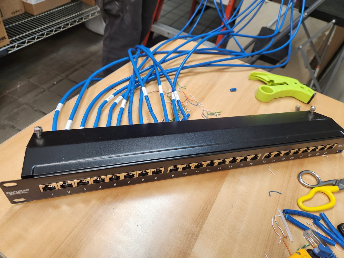 Cat6 patch panel being terminated with blue Ethernet cables