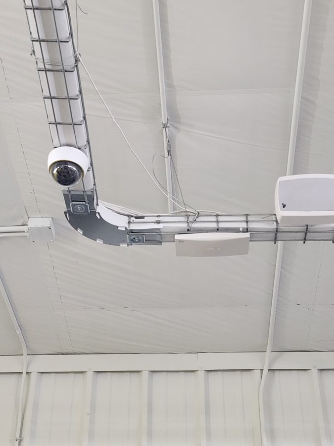 Indoor security camera installation on warehouse ceiling near Indianapolis